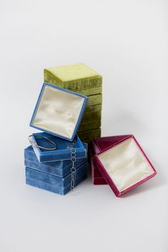 three small jewelry boxes sitting next to each other