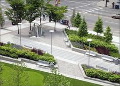 an aerial view of a park with benches, trees and plants on the side walk