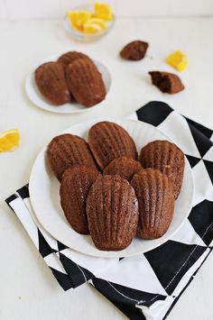 some cookies are on a white plate with black and white napkins