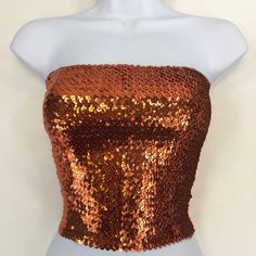 This Orange Sequin Tube Top is made with high quality sequins and a stretchy polyester (Dry clean only). The size of the tube top is about 10.5 inches tall, and it stretches to a bust of about 34 inches. It is stretchy and form fitting. If you have any questions, please feel free to send us a message, and I will be glad to help. Glamorous Bandeau Stretch Tops, Strapless Sequin Party Tops, Strapless Sequin Tops For Parties, Glamorous Bandeau Sequin Crop Top, Sequin Bandeau Top For Party, Strapless Sequined Fitted Tube Top, Fitted Sequin Strapless Tube Top, Glamorous Strapless Sequin Tops, Sequin Fitted Tube Top For Club