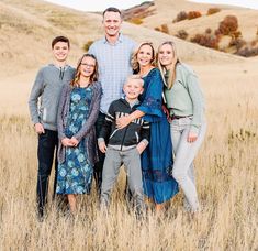 a family posing for a photo in a field