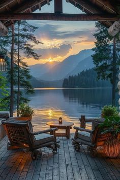 two chairs sitting on top of a wooden deck next to a lake