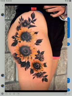 a sunflower tattoo on the thigh