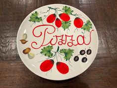 a plate with the word pasta written in cursive writing and cherries on it