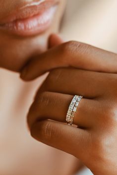 a woman's hand with a diamond ring on her finger