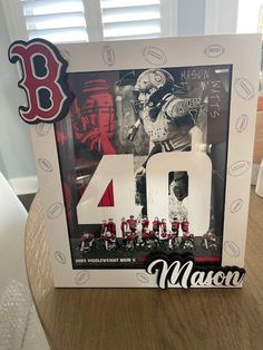 the number forty man is displayed in front of a photo frame with baseball players on it