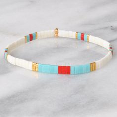 Like little works of art you can wear, these stretch tile bracelets — all in exclusive Libby & Smee patterns — are perfect on their own or in one of our curated sets. Stacking is strongly encouraged. style: PHOENIX glass tile beads in matte ivory, matte red, and turquoise, and gold stretch cords finished with gold-plated crimp covers, lead-free and nickel-free comes in one 7" size to fit most wrists, perfect for stacking with other bracelets packaged in a clear resealing bag for storage and gift giving Pick any three three tile bracelets and save $20: Libby & Smee Tile Bracelet Sets to keep your jewelry looking new, avoid water, lotions and perfumes never swim or shower in your Libby & Smee jewelry White Adjustable Flexible Bracelets, Adjustable Flexible White Bracelets, Adjustable White Flexible Bracelets, White Flexible Bracelets As A Gift, Flexible White Bracelets For Summer, White Stackable Friendship Bracelets For Summer, Flexible White Stretch Bracelet As Gift, Tile Bracelets, Tile Bracelet