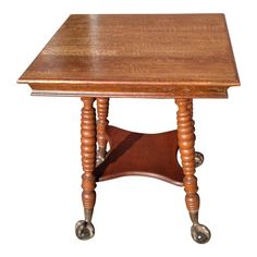 a small wooden table with wheels on the bottom and one leg resting on it's side