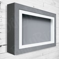 a white and gray frame hanging on the wall