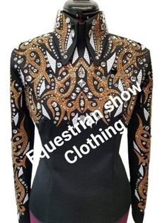 a mannequin wearing a black top with gold and white designs on it