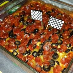 a pizza with pepperoni and olives in a casserole dish