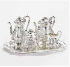 a silver tea set on a tray