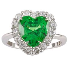 Figural heart shaped ring. Brilliant faceted tsavorite center stone, 3 cts, surrounded by very white full-cut diamonds. Set in platinum. Size 6 and can easily be re-sized. Absolutely gorgeous. Tsavorite Jewelry, Clear Sunglasses Frames, Stunning Aesthetic, Heart Shaped Ring, Garnet Heart, Vintage Cocktail Ring, Diamond Heart Ring, Platinum Diamond Rings, Green Garnet