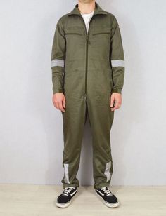 "Fantastic zip through flying suits from the German Airforce. Softened, comfortable thick 100% cotton fabric. Loads of character. Tough and hard wearing design. Features include: - Various zip pockets: chest, hips, knees - Drawstring adjustable waist - German military flying badge to upper arm (some suits may have additional badges) - Adjustable velcro cuffs and ankles - Manufacture dates ranging from late 80s to early 00s - Some have velcro badge patches to chest (for attaching pilot's name bad Khaki Cotton Long Sleeve Jumpsuits And Rompers, Green Cotton Jumpsuits And Rompers With Side Pockets, Green Cotton Jumpsuits With Side Pockets, Military Style Cotton Overalls, Military Style Long Sleeve Cotton Jumpsuit, Military Style Long Sleeve Cotton Jumpsuits And Rompers, Utility Cotton Khaki Jumpsuits And Rompers, Green Long Sleeve Cotton Jumpsuits And Rompers, Green Cotton Long Sleeve Jumpsuits And Rompers