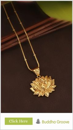 Golden lotus-shaped pendant on a gold chain displayed on a dark background. Gold Pendant Necklace For Rituals, Gold Plated Pendant Necklace For Diwali, Elegant Necklaces For Diwali Rituals, Elegant Necklace For Diwali Rituals, Elegant Engraved Temple Necklace For Rituals, Gold Temple Jewelry Necklace With Flower Pendant, Temple Jewelry Locket For Meditation, Elegant Medallion Jewelry For Rituals, Brass Necklace As Diwali Gift