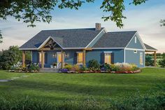 a blue house sitting on top of a lush green field