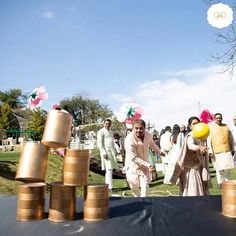 a group of people standing next to each other near stacks of gold coins