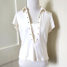 Nwt Vintage Clio White Collared Metal-Studded Short-Sleeved V-Neck Polo. Petite Size L. Never Been Worn. The Back Of One Stud Has Fallen Off, As Pictured. Other Blemishes As Pictured, All From Storage. Make Me An Offer Or Ask Me More Questions Below! Fitted V-neck Blouse For Day Out, Fitted Short Sleeve V-neck Top For Day Out, White Polo Collar Top With Buttons, Cream Cotton Polo Collar Top, White Short Sleeve Polo Shirt With Button Closure, Vintage Cotton Polo Collar Top, Fitted Tunic Tops, White Polo Collar Cotton T-shirt, Fitted Tunic