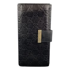 Archive GUCCI checkbook wallet comes in black Guccissima monogram embossed leather with a flap pocket back, flap front with gold tone accented tab snap closure, and internal storage. Snap is loose. As-is. Made in Italy.Good Pre-Owned Condition. Marked: 212089.04167.5 x 4 inches Reference: 97792 Category: Handbag & Leather Goods More Details Brand: GUCCI Color: Black Pattern: Monogram Fabric: Leather Style Bag: Wallet Shape/Cut: Rectangle Age Group: Adult Gender: Female Gucci Top Handle Bag, Checkbook Wallet, Jewelry Roll, Gucci Monogram, Gold Monogram, Ostrich Leather, Small Accessories, Metallic Logo, Vintage Accessories