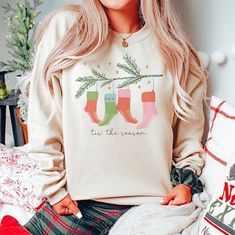 Spread some holiday cheer with this cute and comfyChristmas sweatshirt featuring holiday-themed hospital socks. It's perfect for anyone at the hospital who could use a little humor at work! Add your name to the sleeve of this sweatshirt by purchasing your customization here: https://www.etsy.com/listing/1541588602 Our designs are printed DTG (direct to garment) on Gildan brand sweatshirts. Ideal for any situation, this healthcare professional Christmas crewneck sweatshirt is pure comfort! The co Casual Christmas Cotton Sweatshirt, Casual Cotton Christmas Sweatshirt, Casual Christmas Sweater With Relaxed Fit, Cozy Christmas Sweatshirt With Relaxed Fit, Cozy Relaxed Fit Christmas Sweatshirt, Christmas Relaxed Fit Sweatshirt For Loungewear, Christmas Cotton Sweatshirt For Loungewear, Relaxed Fit Christmas Loungewear Sweatshirt, Casual Christmas Sweater For Loungewear