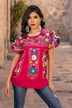 This Beautiful Hand embroidered blouse has a unique Mexican inspired Floral design and embroidered split sleeves. The blouse is a fresh cotton linen embroidered with cotton string. Paired with your favorite pair of jeans or a cute pair of shorts, the Floral Embroidered Camelia Top is a Solei favorite.  This distinctive embroidery design originated in Puebla, Mexico.  We have a deep appreciation for these beautiful works of art and the artisans who create them. With your help, we will support the Summer Cotton Blouse With Embroidered Sleeves, Cotton Folk Top With Embroidered Sleeves, Cotton Blouse With Multicolor Embroidered Sleeves, Cotton Blouse With Multicolor Embroidery And Embroidered Sleeves, Summer Blouse With Machine Embroidery, Bohemian Cotton Tops With Machine Embroidery, Red Crew Neck Blouse With Floral Embroidery, Traditional Cotton Top With Embroidered Sleeves, Pink Folk Style Cotton Tops