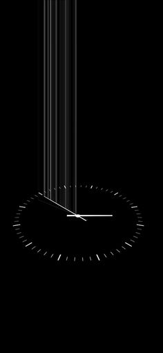 a black and white photo of a clock in the dark