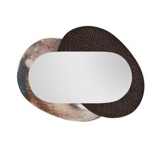 an oval mirror with two circular mirrors on the side and one round mirror in the middle