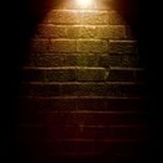 a brick wall with a light shining on it