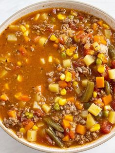 a white bowl filled with soup and vegetables