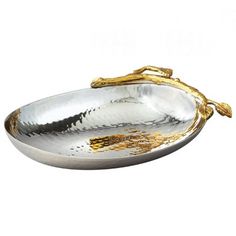 a silver and gold serving dish with handles