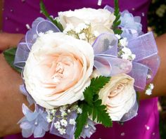 a bridesmaid's bouquet with pink and white flowers on her arm,