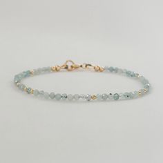 Elevate your style with this dainty aquamarine pale blue crystal bracelet. Adorned with minimalist gemstone beads, this beaded bracelet is a perfect March birthstone accessory. This exquisite piece doubles as a sentimental 19th-anniversary gift for women, making it a thoughtful and stylish Mom gift idea. * Genuine blue aquamarine gemstone beads * March Birthstone * 19th wedding anniversary gift * 2mm - 2.5mm faceted gemstone beads * 14k gold fill or sterling silver  * Chain and findings are nick Delicate Faceted Beaded Bracelets For Everyday, Dainty Faceted Beaded Bracelets For Everyday Wear, Minimalist Crystal Bracelet With Faceted Beads For Everyday, Minimalist Everyday Crystal Bracelet With Faceted Beads, Adjustable Aquamarine Beaded Bracelets, Delicate Blue Bracelets For Everyday, Dainty Crystal Bracelet With Gemstone Beads For Everyday, Elegant Turquoise Aquamarine Beaded Bracelets, Light Blue Adjustable Dainty Jewelry