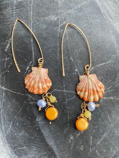 Sunset shell dangly earrings made with gold and pearls. Almost 3 inches long. One ear wire is damaged. Beautiful. Gold Wire Wrapped Dangle Linear Earrings, Gold Pearl Dangle Linear Earrings, Gold Pearl Shell-shaped Earrings, Handmade Gold Shell Pearl Earrings, Gold Shell-shaped Earrings With Ear Wire, Gold Beaded Dangle Earrings With Pearl Drop, Gold Dangle Beaded Earrings With Pearl Drop, Gold Dangle Linear Earrings With Pearl Charm, Gold Pearl Earrings With Wire Wrapped Detail