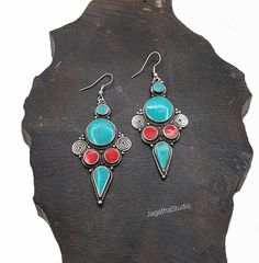 HANDMADE Stunning Ethnic Nepali earrings with Coral & Turquoise gemstones bohemian Tibetan Earrings. A beautiful piece that won't be unnoticed. Turquoise is the most legendary of all stones in the world of healing minerals. It made an appearance in ancient Egypt around 6000 BCE where it was incorporated Into protective amulets. It was considered a sacred stone by the Native Americans, who used it as a powerful healing tool. Considered a master healing stone because it promotes and energetic flow Traditional Festival Earrings With Stones, Bohemian Gemstone Chandelier Earrings, Bohemian Gemstone Dangle Chandelier Earrings, Bohemian Gemstone Chandelier Dangle Earrings, Bohemian Red Gemstone Earrings, Bohemian Gemstone Chandelier Drop Earrings, Bohemian Blue Gemstone Earrings, Bohemian Turquoise Earrings For Festival, Bohemian Red Earrings With Natural Stones