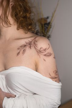 a woman with a tattoo on her shoulder