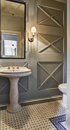 a white sink sitting under a bathroom mirror