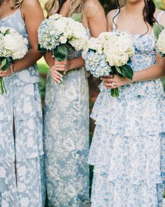 the bridesmaids are holding their bouquets together