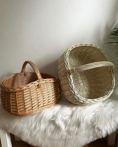 two wicker baskets sitting on top of a white bench