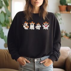 Stay cozy and stylish in our Cowboy Ghosts Sweatshirt. This western-inspired sweater features cute ghost designs that will add a playful touch to your wardrobe. Get ready to turn heads and keep warm in our unique and fun sweatshirt. Oversized Fall Sweatshirt With Character Print, Fall Character Print Relaxed Fit Sweatshirt, Cute Fall Sweatshirt With Character Print, Oversized Fun Sweatshirt For Fall, Fun Oversized Sweatshirt For Fall, Ghost Design, Fun Sweatshirts, Cute Ghost, Stay Cozy