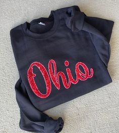 These Ohio sequin sweatshirts are super comfy as well as the perfect touch with boots and jeans!  Sweatshirts are unisex and the sweatshirt color can be changed!  ❗️Sizes: Toddler-2T-5T  Youth XS-XL  Adult S-XL  Adult 2X- Adult 3X  The ash gray sweatshirt has a red sequin Ohio stitched onto the sweatshirt. We also have demos of the black sweatshirt and the graphite heather gray which is a bit darker.  If you would like to request a custom order, please send us a message!! Ohio State Sweatshirt, Ohio Sweatshirt, Sequined Sweatshirt, Red Sequin, Cute Sweatshirts, Ohio State, Grey Sweatshirt, Daughter Love, Heather Grey