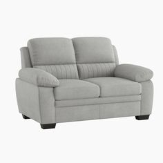 a gray couch sitting on top of a white floor