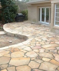 a stone patio with steps leading up to it