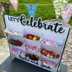 there is a sign that says let's celebrate and lots of candies on it