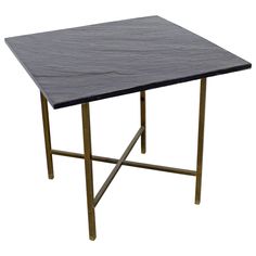 a black marble table with gold legs on a white background for use as a coffee table