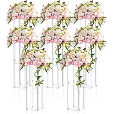 six tall vases with pink and white flowers in them on a white background for display