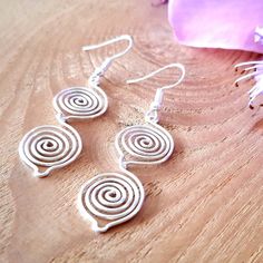 Double Silver Spiral Earrings A great Christmas or birthday gift idea, for someone who loves dangly earrings! ~ These wire wrapped dangle drop earrings have two silver leaf spirals. ~ Simple unique dainty earrings, perfect for any occasion, wear it with jeans and t-shirt or a formal frock. 💙 Made in a choice of silver, use the finish option box to choose from silver plated, 925 sterling silver or 99.99% fine silver (a certificate of authentication will be provided). 💝 GIFTS We can ship our pro Wire Wrapped Swirl Earrings For Gift, Wire Wrapped Swirl Earrings As Gift, Spiral Wire Wrapped Silver-plated Earrings, Wire Wrapped Spiral Earrings In Silver Plated Wire, Spiral Silver Plated Wire Earrings For Gift, Spiral Silver Plated Wire Earrings As Gift, Spiral Wrap Earrings As Gift, Spiral Wire Wrapped Silver Plated Earrings, Silver Plated Wire Wrapped Spiral Earrings