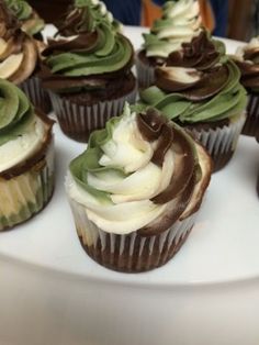 cupcakes with green and white frosting on a plate