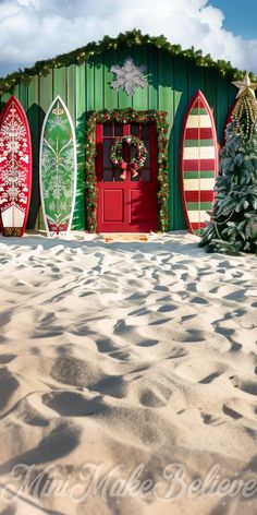 surfboards are lined up in front of a green building with snow on the ground