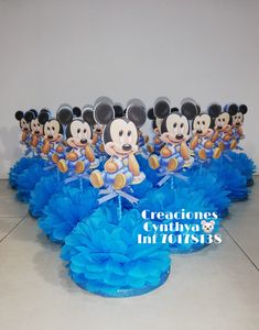 a group of mickey mouse cake toppers with blue ruffles