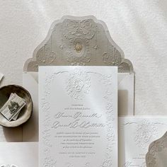 the wedding stationery is laid out on top of each other